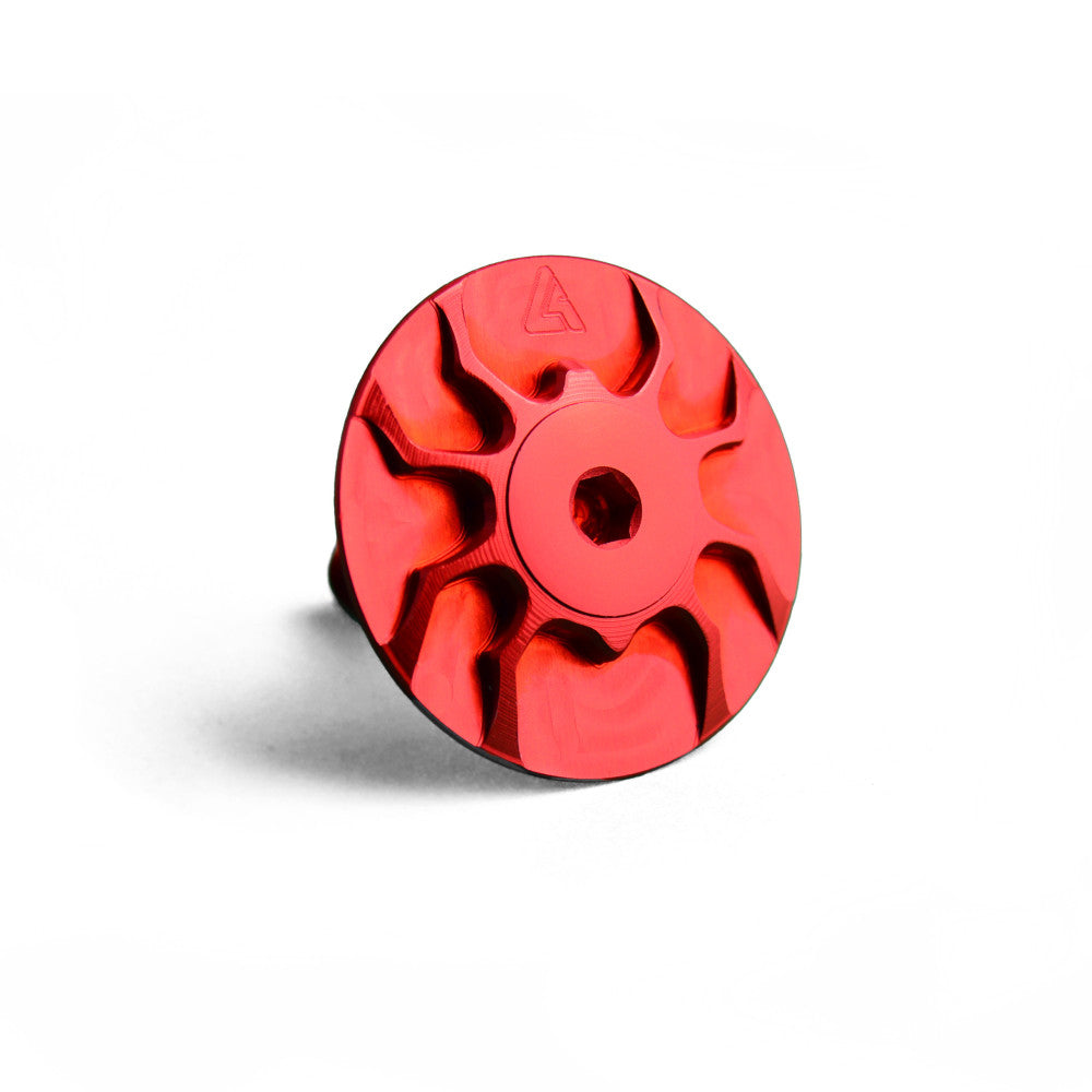 Red anodized ALUGEAR headset top cap with turbine spider design and center hex bolt socket