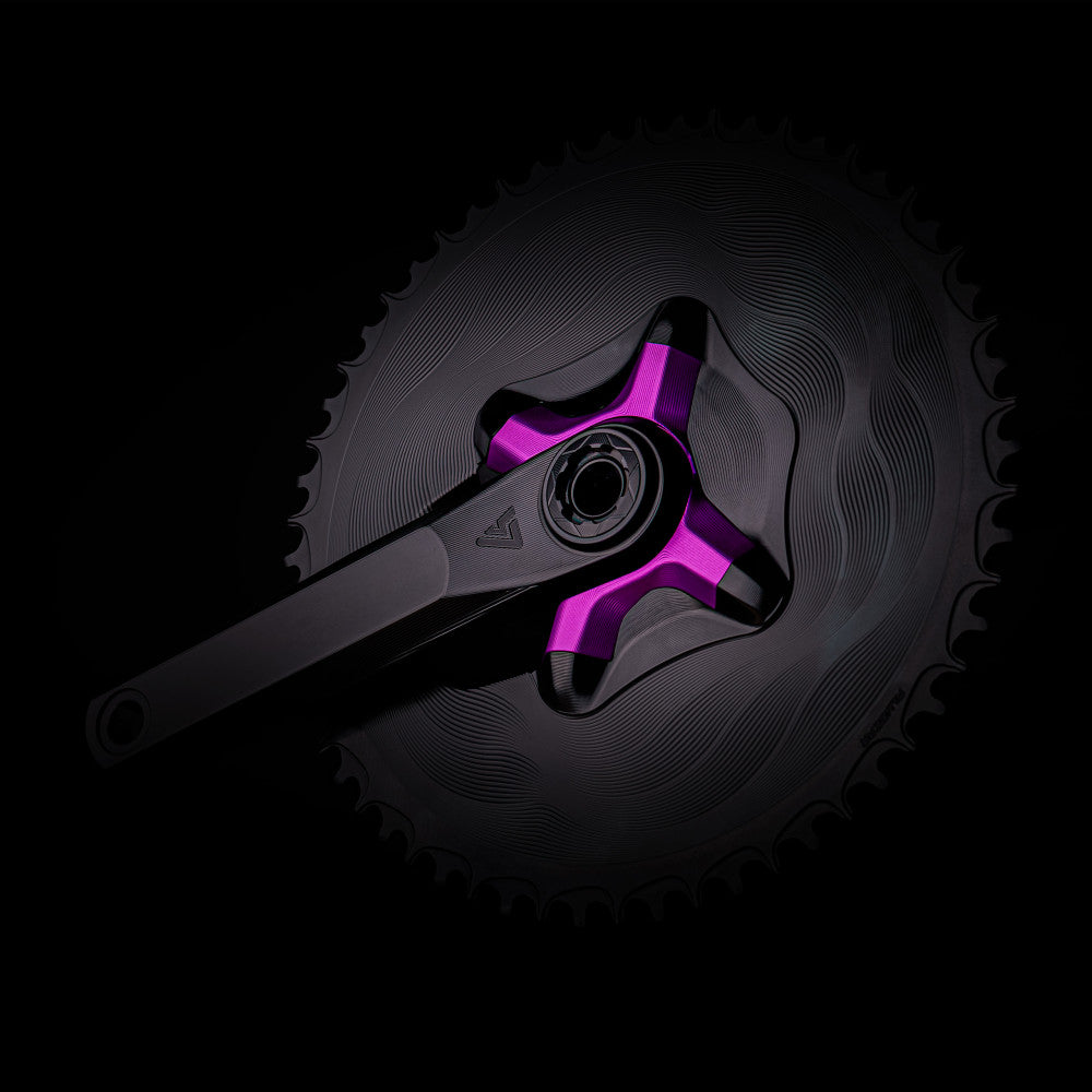 Purple anodized ALUGEAR crank spider on black road crank with large AERO chainring, dark background lifestyle