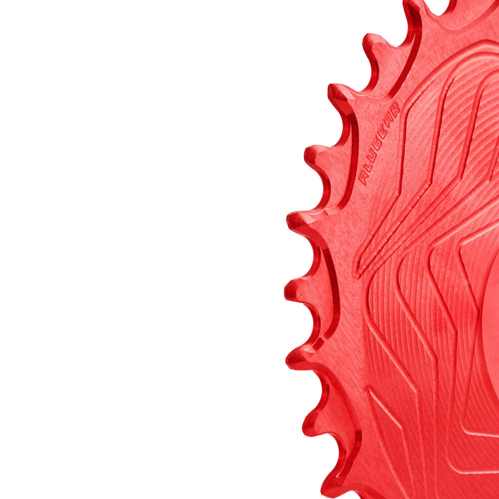 Close-up of red anodized ALUGEAR Shimano direct-mount 12sp MTB chainring teeth with wave-machined surface