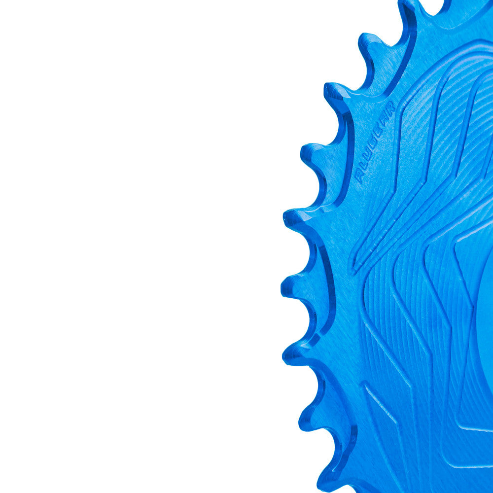 Blue anodized ALUGEAR Boost AERO MTB chainring close-up showing narrow-wide teeth and wave body, Race Face Cinch direct-mount