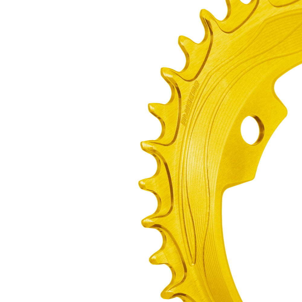 Gold anodized ALUGEAR 94/96 BCD 4-bolt MTB chainring, macro close-up of narrow-wide teeth with flow-line machining