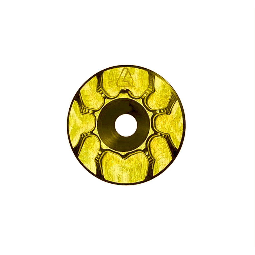 Gold anodized ALUGEAR headset top cap with spider cut-out design, front face view