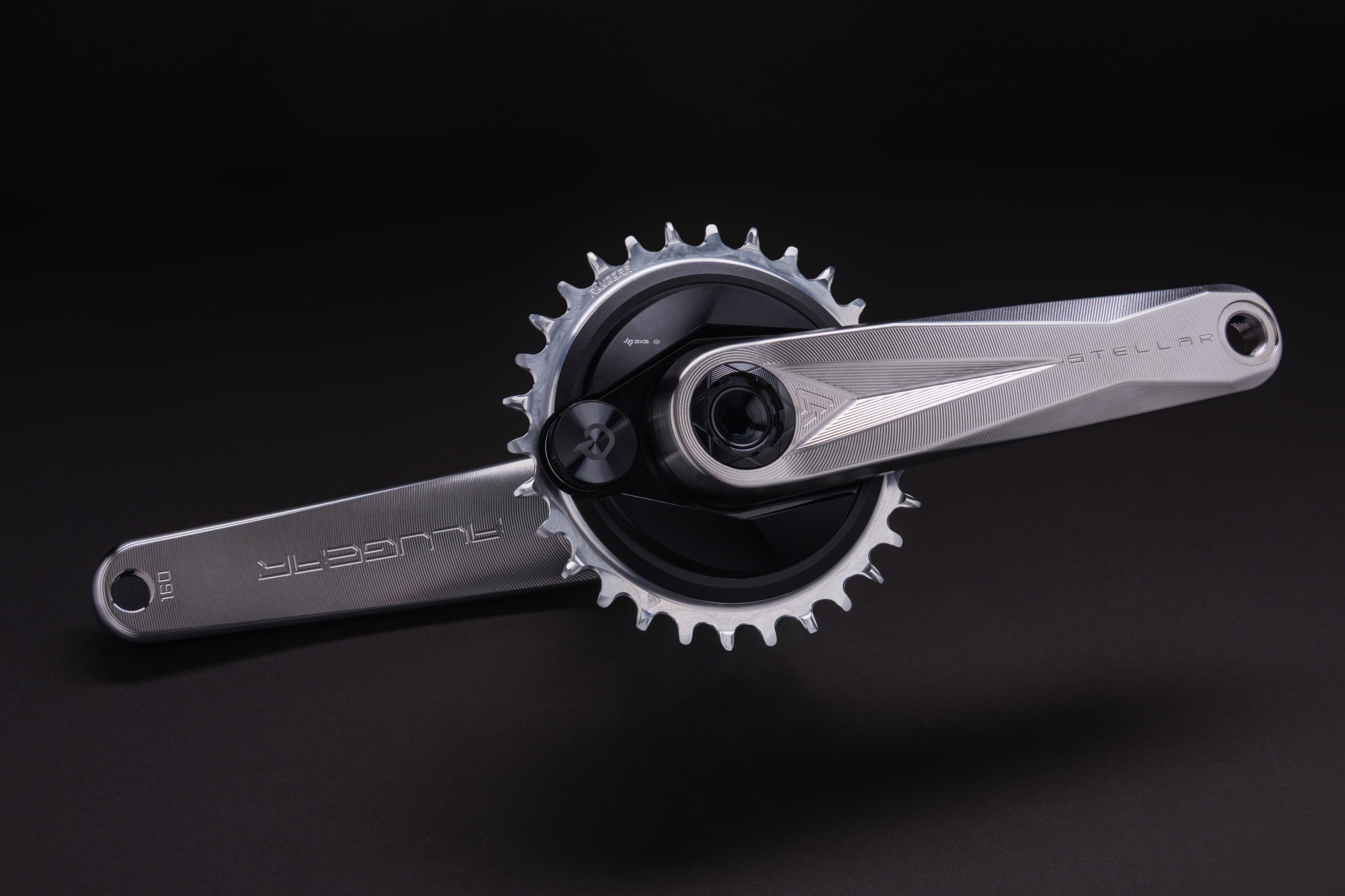 Silver ALUGEAR Stellar MTB crankset with narrow-wide chainring, splined spindle interface, dark background