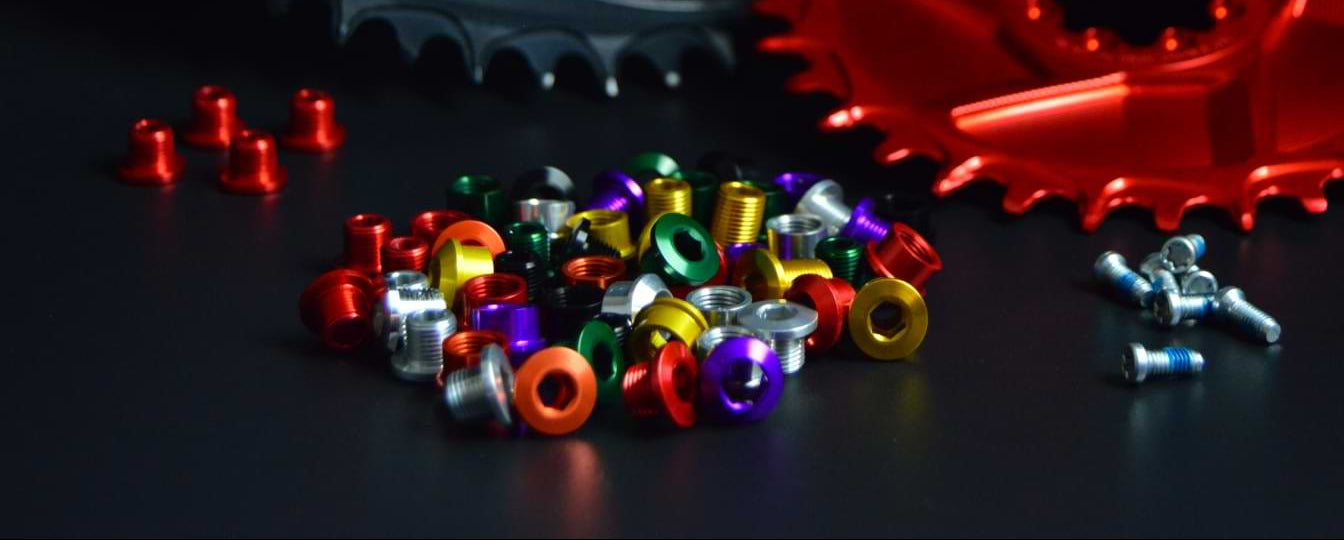 Assorted ALUGEAR anodized chainring bolts and nuts in multiple colours: red, gold, green, purple, orange, silver