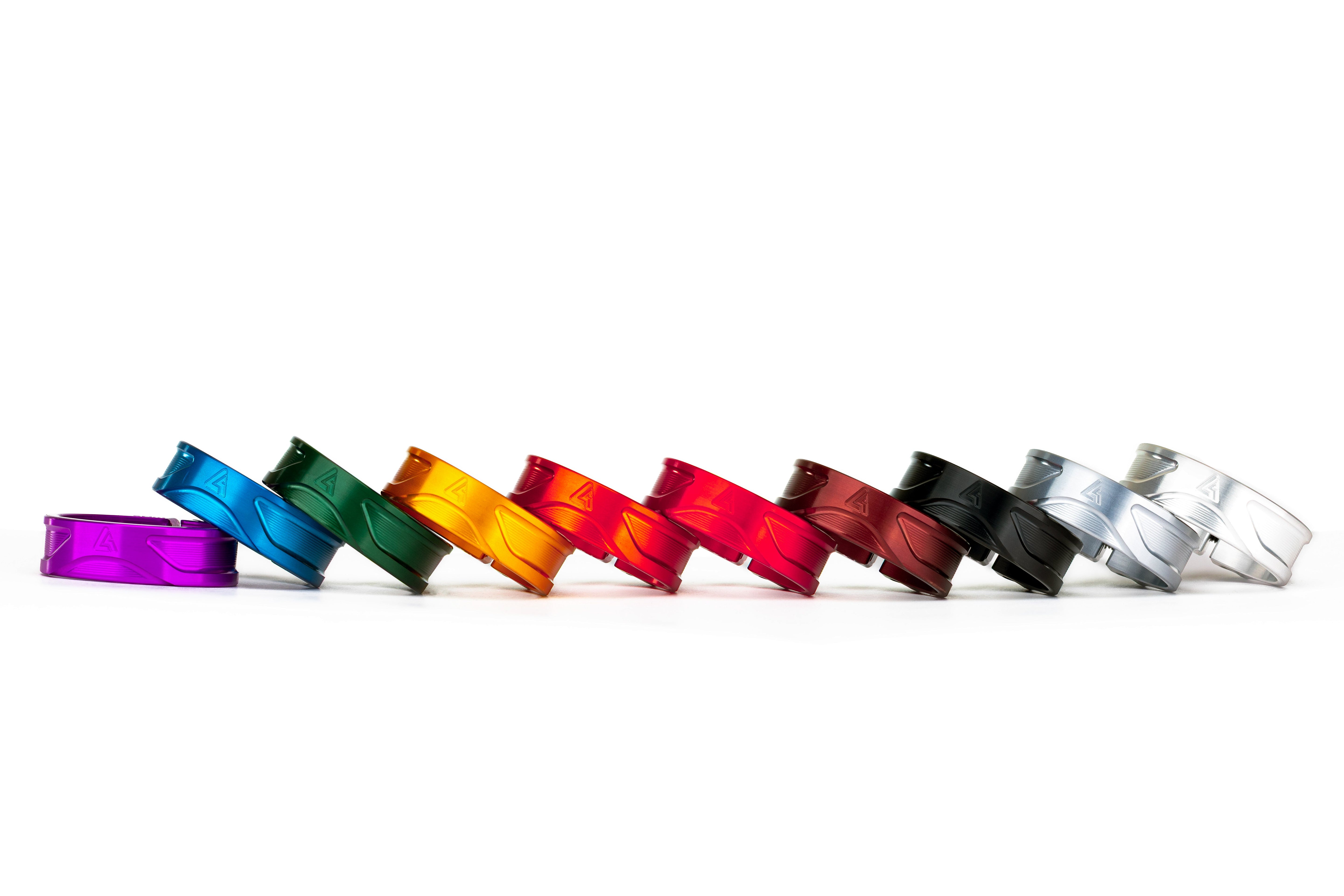 Row of ALUGEAR seatpost clamps in anodized colours: purple, blue, green, orange, red, dark red, black and silver