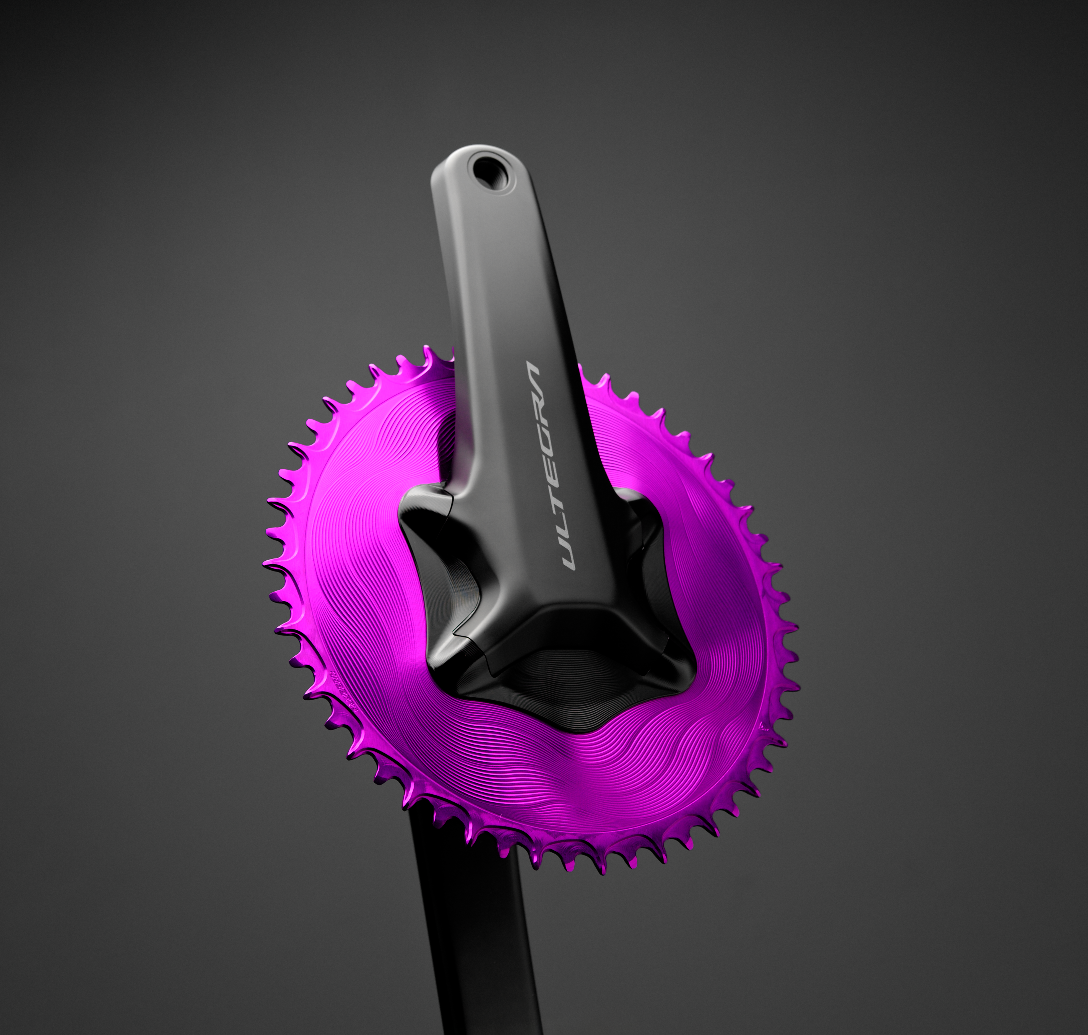 Purple ALUGEAR AERO 1X chainring installed on Ultegra crank arm, dark studio background, wave-machined surface