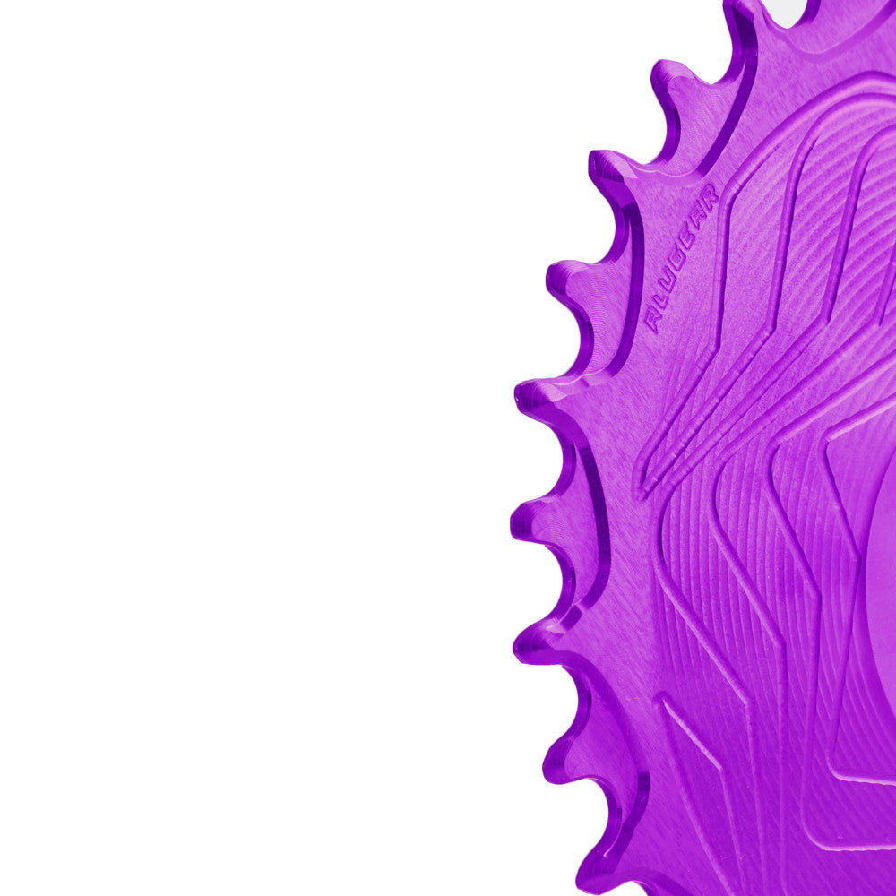 Close-up of purple anodized ALUGEAR Shimano direct-mount 12sp MTB chainring teeth, wave-machined surface