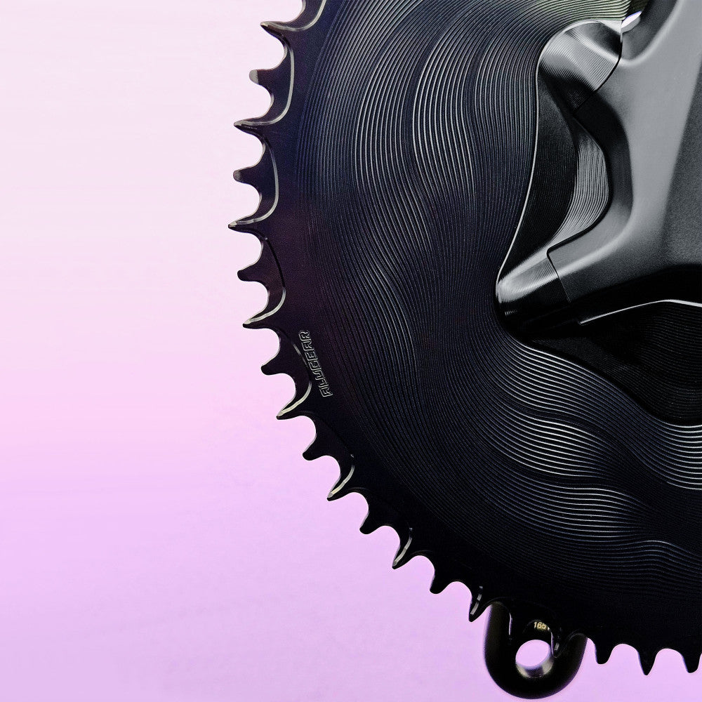 Close-up of black ALUGEAR round road chainring teeth on Shimano Ultegra crank, 110 BCD 4-bolt asymmetric, wave-pattern body