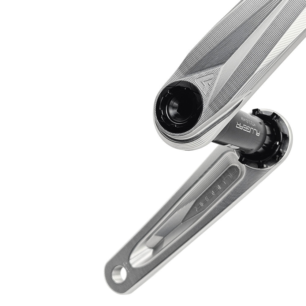 Close-up of silver ALUGEAR Stellar AL MTB crankset DUB spindle junction, MTB DUB Wide label visible