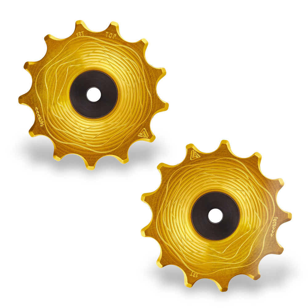 Pair of gold anodized ALUGEAR AERO MTB rear derailleur pulleys, 13T+13T, Shimano 12-speed, wave-machined face