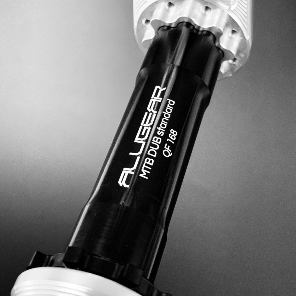 Close-up of ALUGEAR DUB MTB standard spindle engraved QF 168 label, installed in silver Stellar AL crank