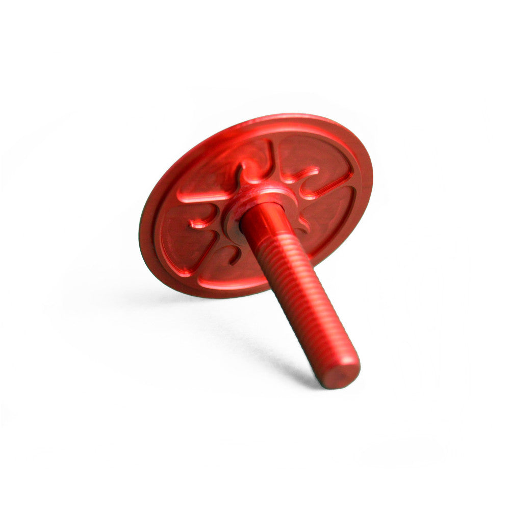 Red anodized ALUGEAR headset top cap showing underside stem bolt, turbine spider pattern
