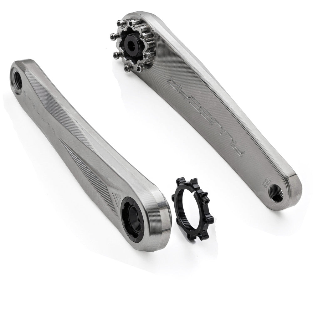 Two titanium ALUGEAR Stellar Ti MTB crank arms with preload ring, three-quarter exploded view