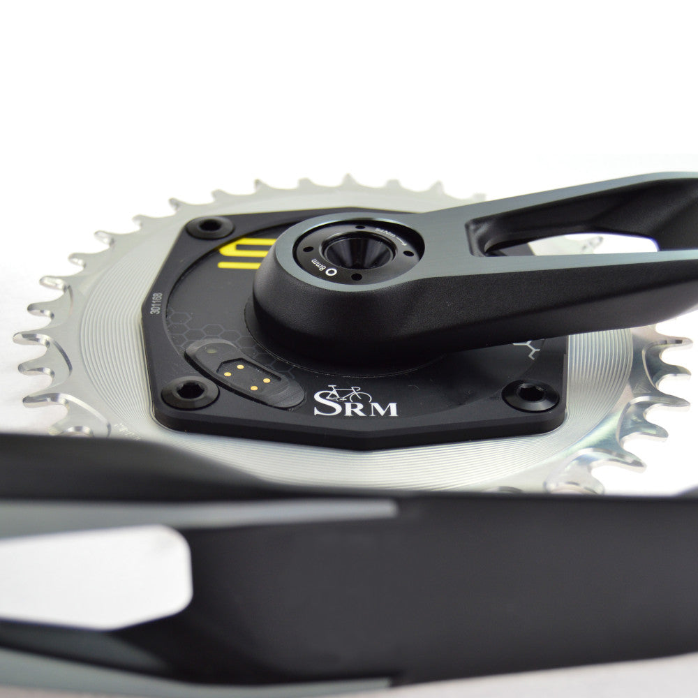 Silver ALUGEAR round AERO chainring installed on SRM power meter crank, close-up showing 104 BCD interface