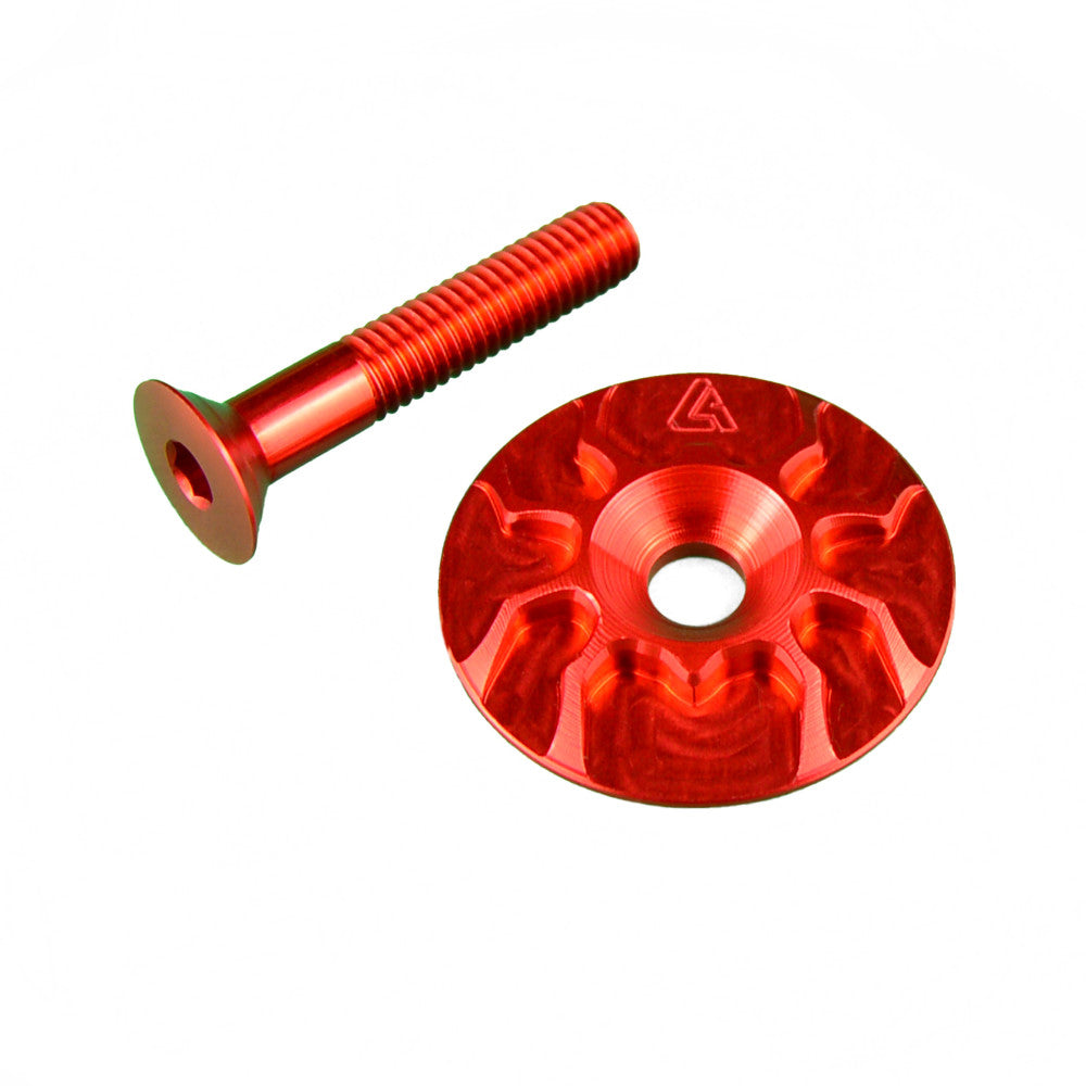 Red anodized ALUGEAR headset top cap and M6 countersunk bolt, flat-lay pair