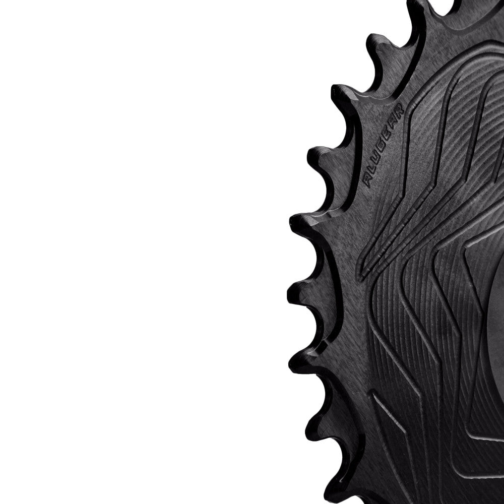 Close-up of black ALUGEAR Shimano direct-mount 12sp MTB chainring teeth showing wave-machined spider surface