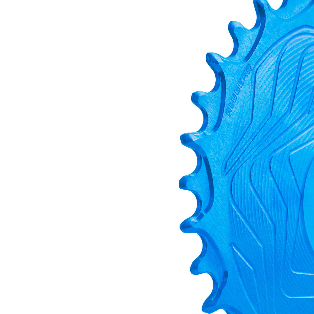 Close-up of blue anodized ALUGEAR Shimano direct-mount 12sp MTB chainring teeth, wave-machined surface