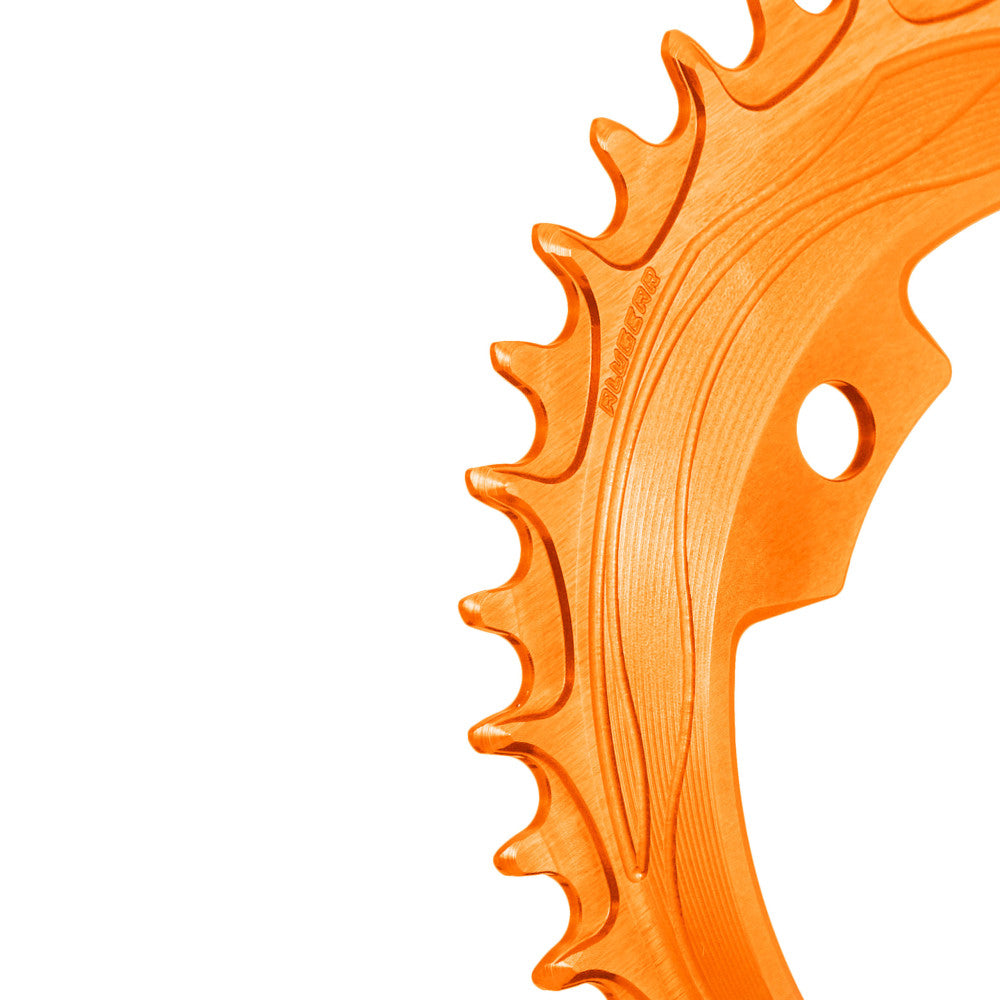 Orange anodized ALUGEAR 94/96 BCD 4-bolt MTB chainring, macro close-up of narrow-wide teeth with flow-line machining