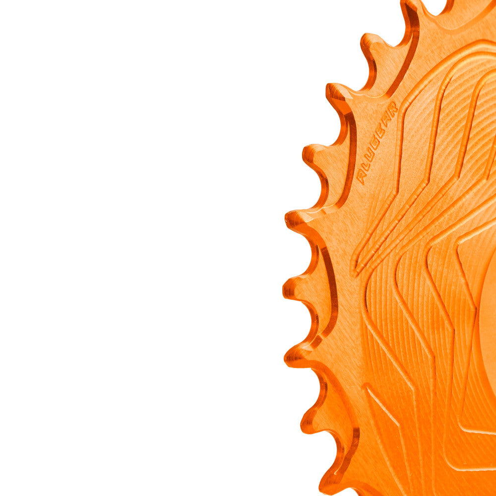 Close-up of orange anodized ALUGEAR Shimano direct-mount 12sp MTB chainring teeth, wave-machined surface