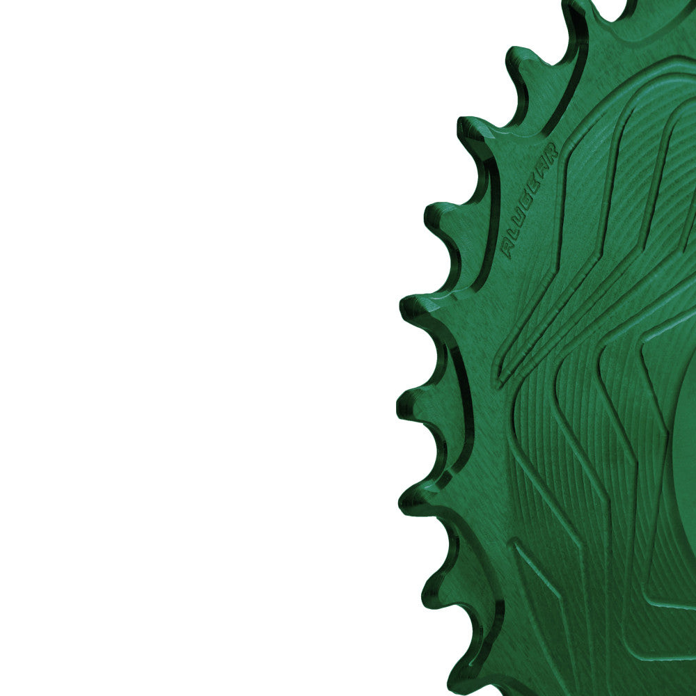 Close-up of green anodized ALUGEAR Shimano direct-mount 12sp MTB chainring teeth, wave-machined surface