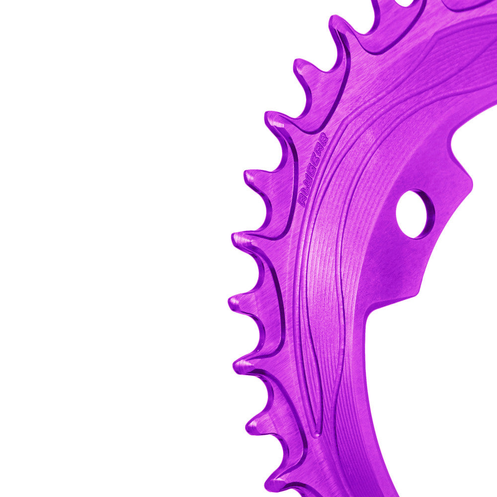 Purple anodized ALUGEAR 94/96 BCD 4-bolt MTB chainring, macro close-up of narrow-wide teeth with flow-line machining