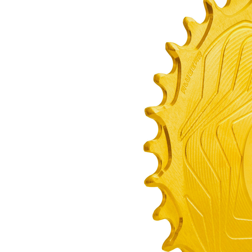 Close-up of gold anodized ALUGEAR Shimano direct-mount 12sp MTB chainring teeth, wave-machined surface